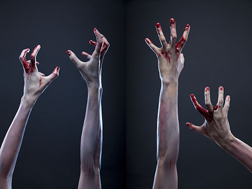 Creepy set of bloody zombie hands, studio shot over gray backgro
